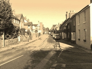 The High Street from the German end. Jones and Pike defending from the upper window of the house on the left in the distance.